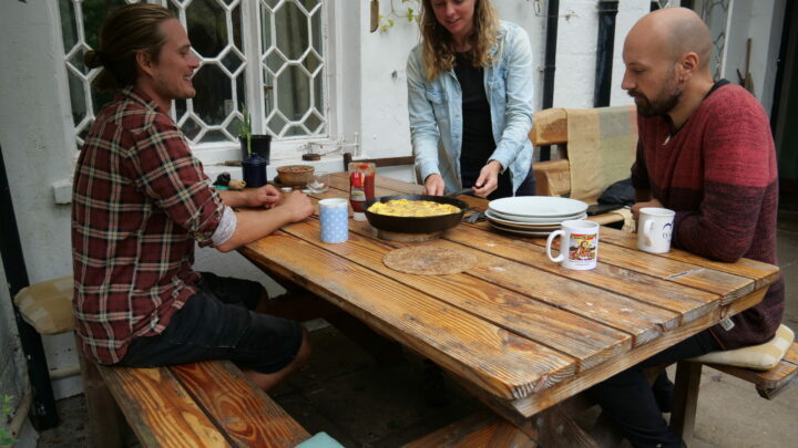 three members of Tir Cyffredin housing co-operative have breakfast together