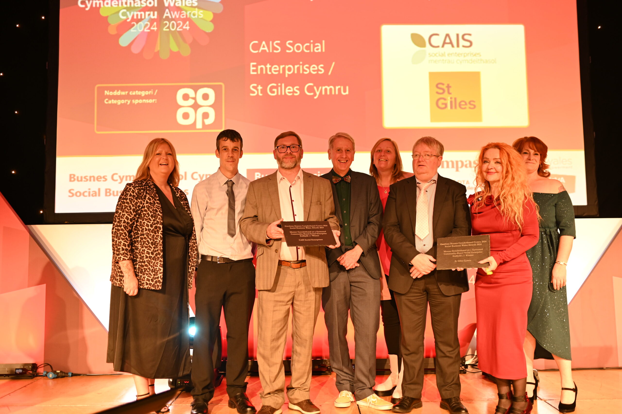 CAIS Social Enterprises and St Giles Cymru collect their award at the Social Business Wales Awards 2024