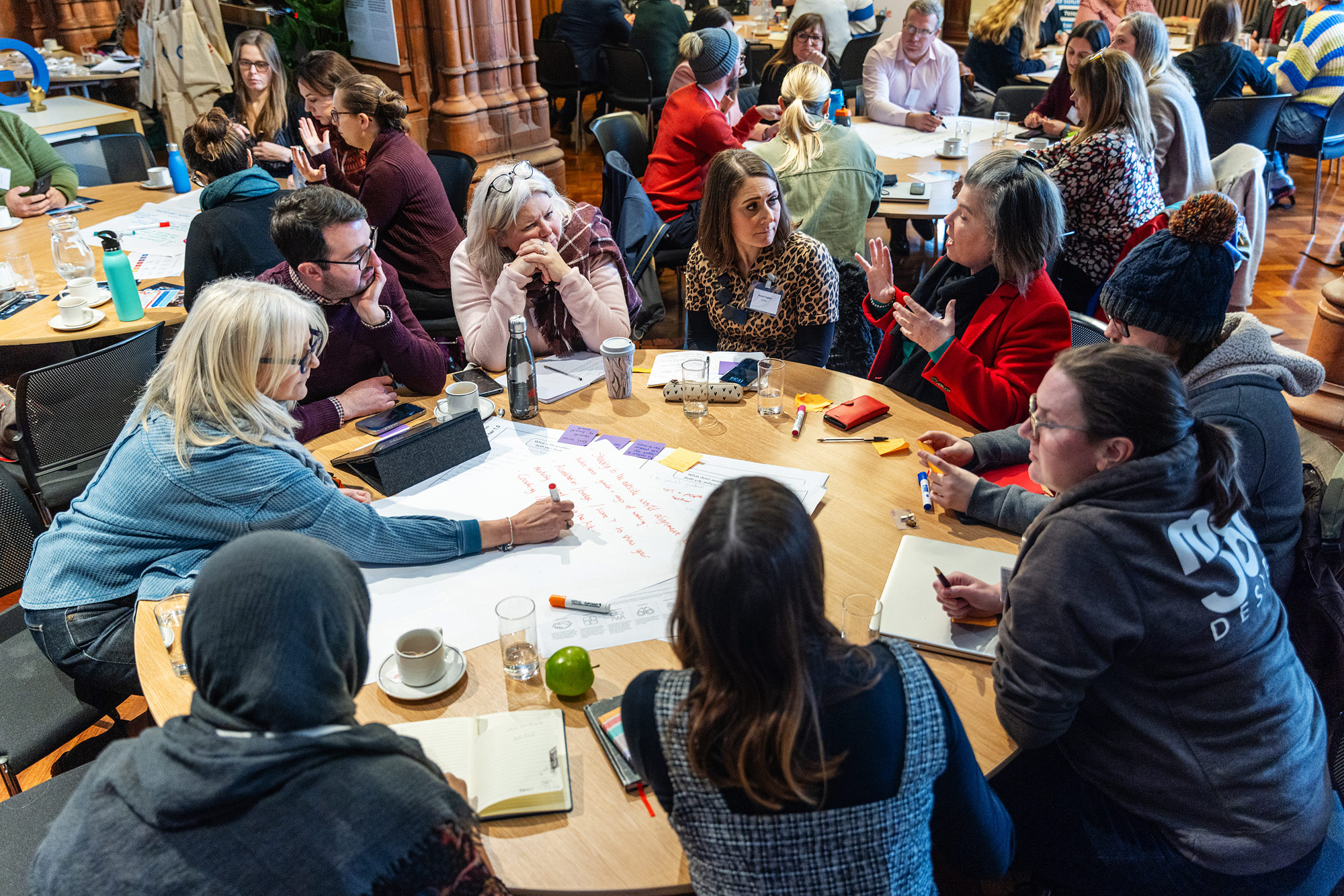 A photo of a Start Something Good Event, with people gathered around a table.